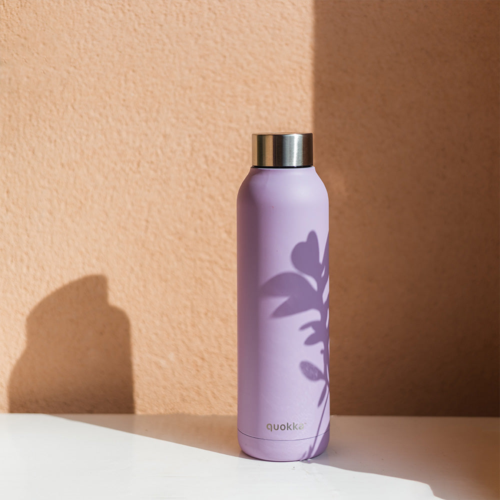 Purple insulated bottle with a plant silhouette, stainless steel cap, on a light background.