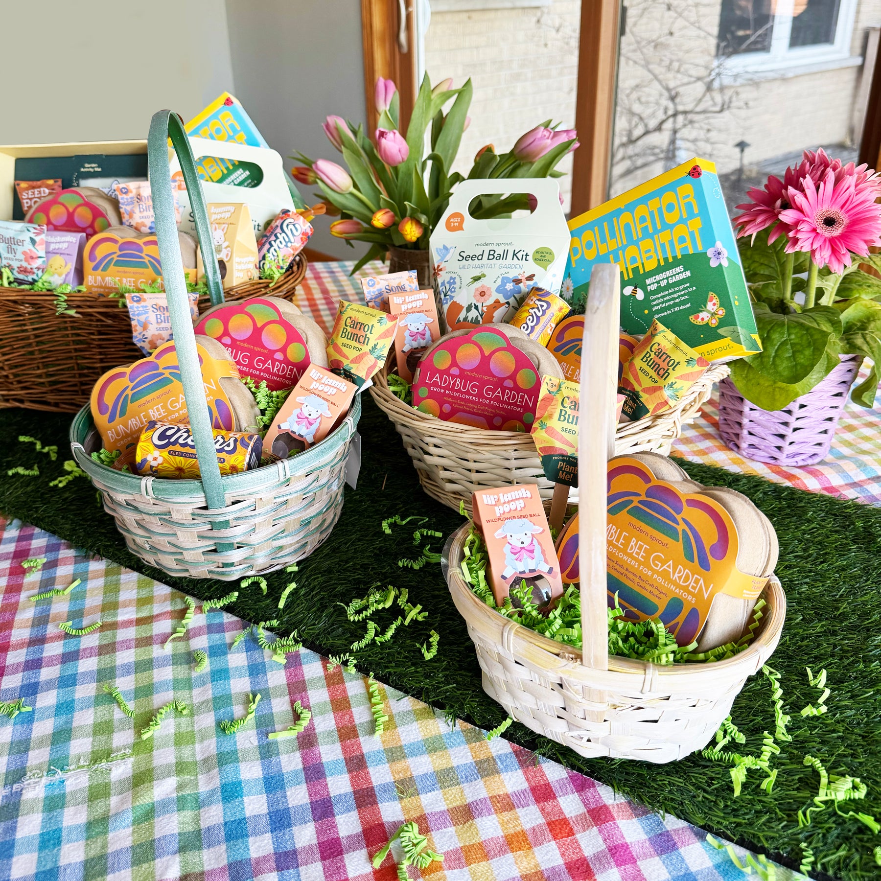 Colorful limited edition Easter baskets filled with gardening kits, candy, and festive decorations on a checkered tablecloth.