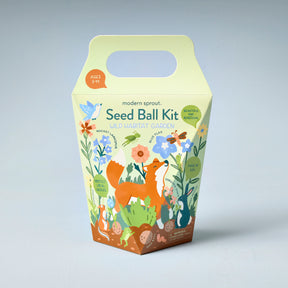 Colorful seed ball kit packaging featuring a fox and various plants, designed for creating a wild habitat garden.