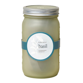 Green glass garden jar featuring a label for a basil hydroponic grow kit, designed for indoor gardening.