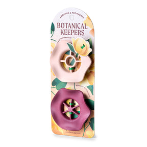 Two Botanical Keepers in pink and burgundy packaging, designed for arranging and propagating plant cuttings.