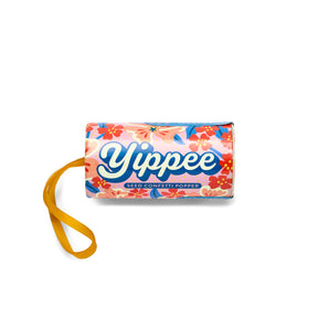 Colorful seed confetti popper with floral design and yellow pull string, labeled "Yippee" for festive planting fun.
