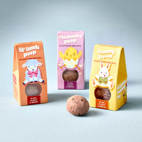 Colorful seed balls for planting wildflowers, packaged as Easter-themed "poop" products: lamb, chick, and bunny designs.