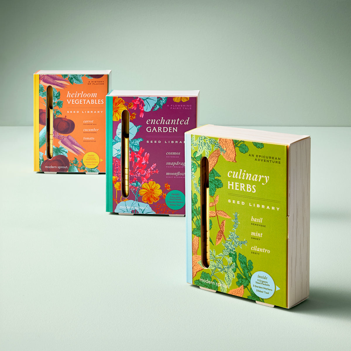 Three colorful seed library boxes titled "Heirloom Vegetables," "Enchanted Garden," and "Culinary Herbs," showcasing vibrant floral designs.