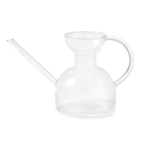 Clear glass watering can with a long spout and a rounded body, designed for easy plant watering.