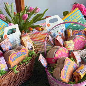 Colorful limited edition Easter baskets filled with seed kits, gardening supplies, and vibrant decorations, surrounded by tulips.