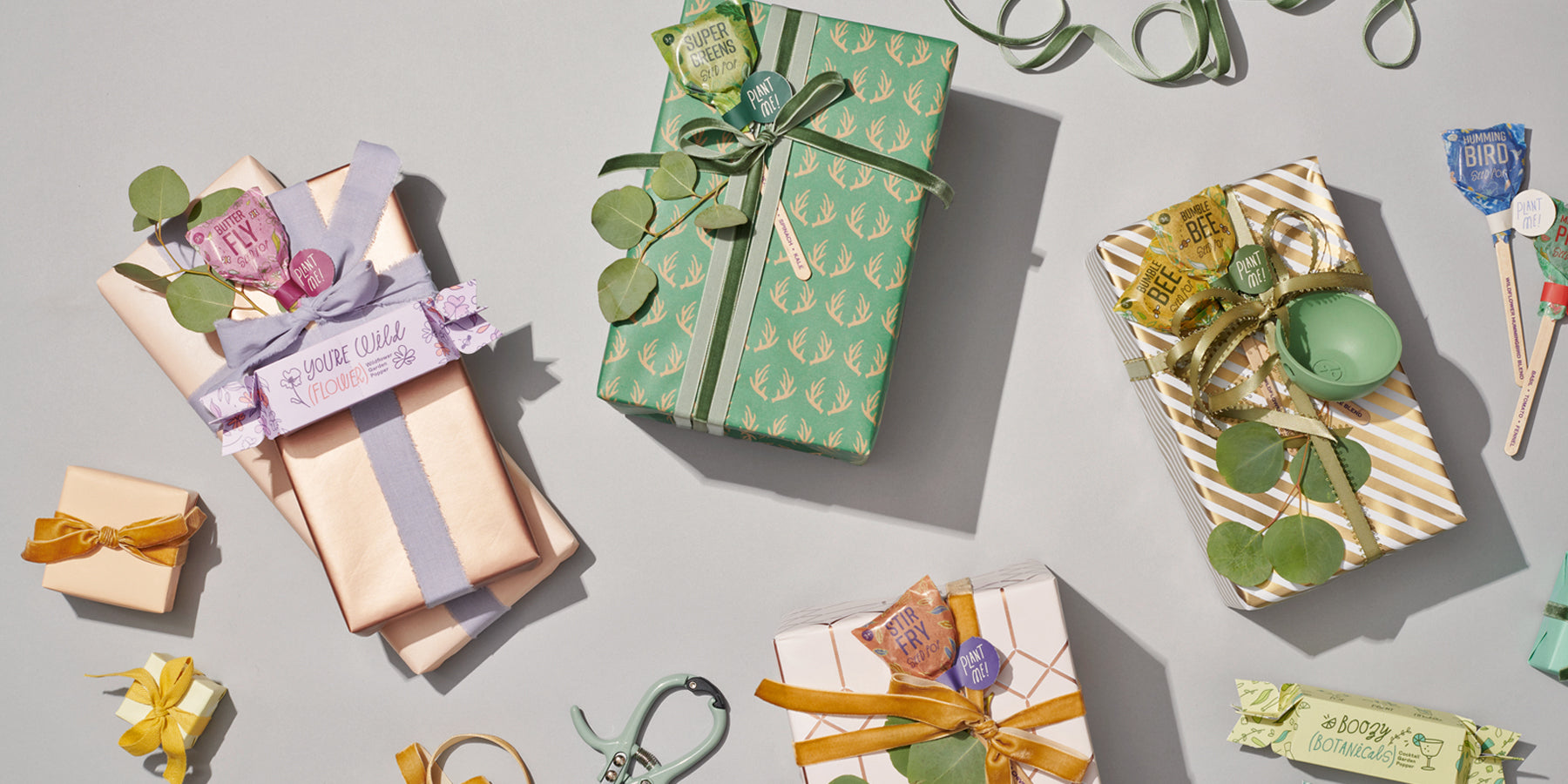 Colorful wrapped gifts in green, gold, and pastel shades, adorned with ribbons and greenery, perfect for indoor gardening ...