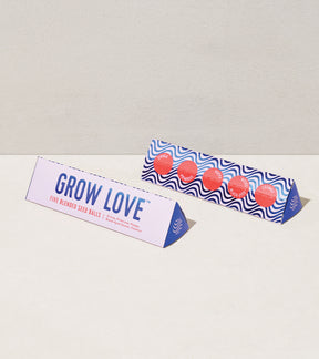 Bright Side Seed Balls packaging featuring "Grow Love" and colorful seed ball designs, ideal for planting flowers and herbs.