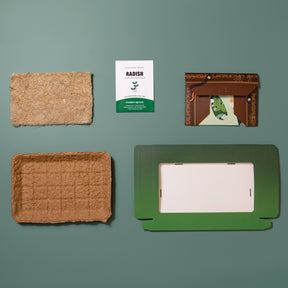 Microgreens Pop-Up Kit components including seed packet, growing medium, and pop-up planter for easy home gardening.