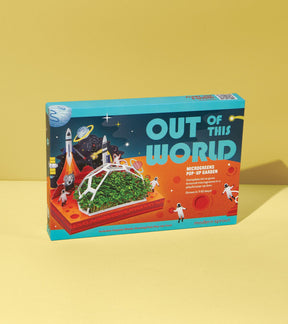 Microgreens Pop-Up Kit box featuring vibrant graphics of astronauts and a mini garden, set against a yellow background.