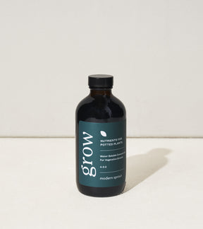8 oz bottle of Modern Sprout plant nutrients for potted plants, featuring a dark label with the word "grow" prominently displayed.