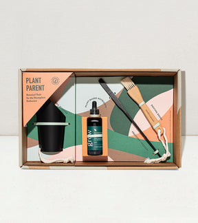 Botanical gift box set featuring a planter, plant care tools, and nutrient solution for plant enthusiasts.