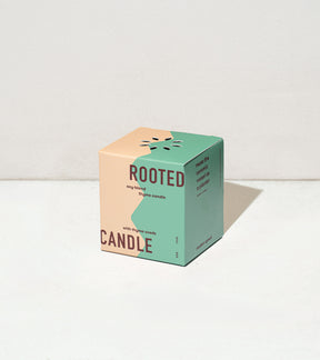 Colorful cube packaging for Rooted Candles features a thyme scent, with a design showcasing thyme seeds.